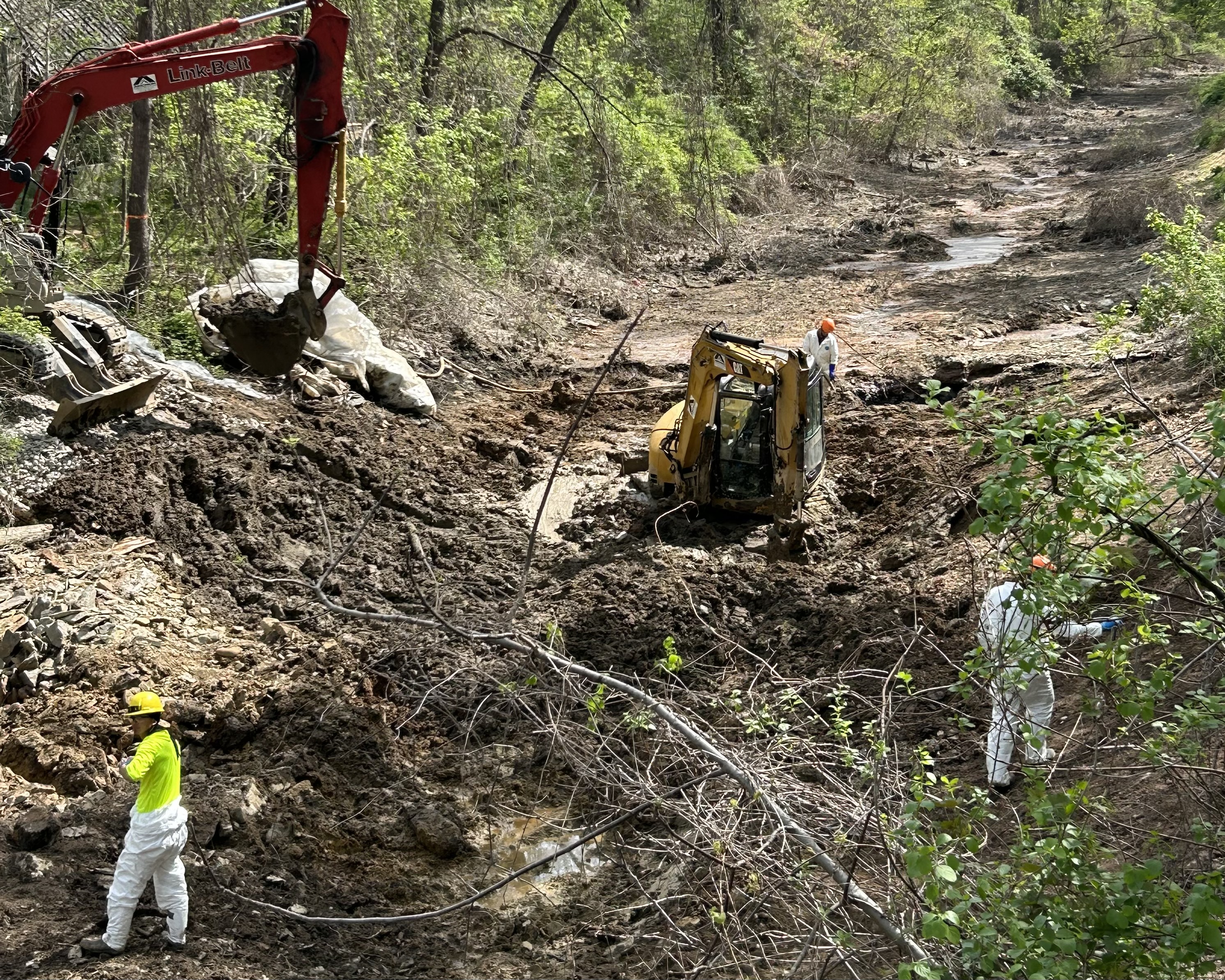 Workers removing soil in canal and excavating soil