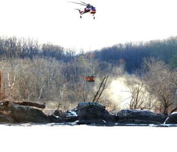 Helicopter carrying drill rig equipment to boring locations in the Potomac River