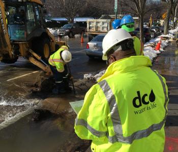 Workers fixing a water main break during the winter