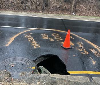 Photo of sinkhole on Suitland Parkway with hole in the road.