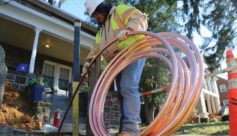 Photo of a worker installing copper pipe