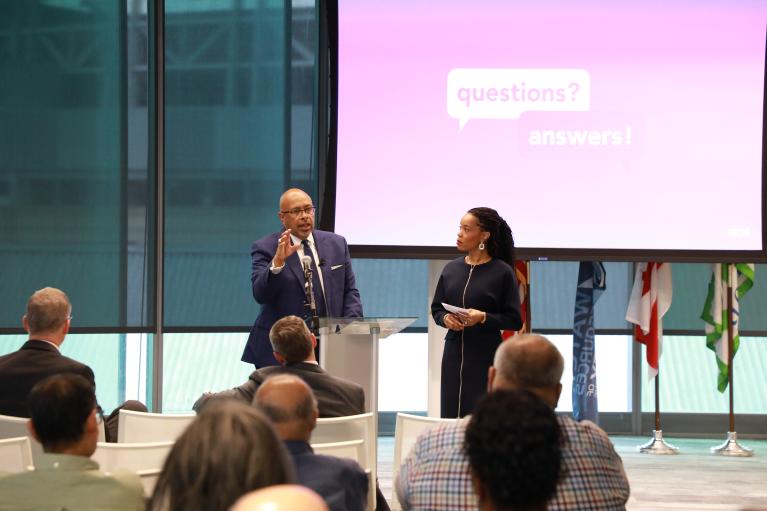 Photo of CEO David Gadis and Chief Communications and Stakeholder Engagement Officer Kirsten Williams addressing the audience at a town hall meeting.