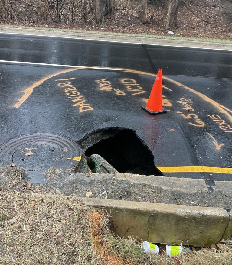 Photo of sinkhole on Suitland Parkway with hole in the road.