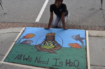 Artist and storm drain painting