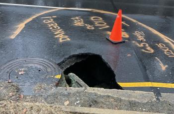 Photo of sinkhole on Suitland Parkway with hole in the road.