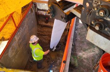 Worker in pit, rehabbing water main