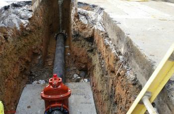 Cast-iron water main in trench.